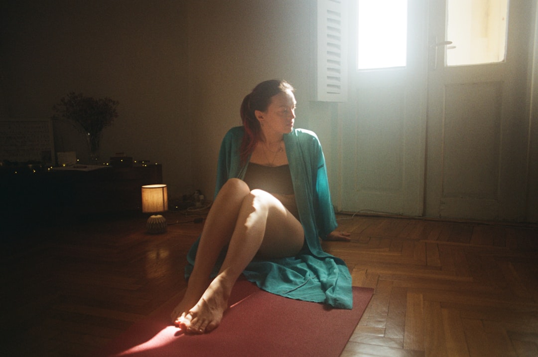 person meditating by window sunlight
