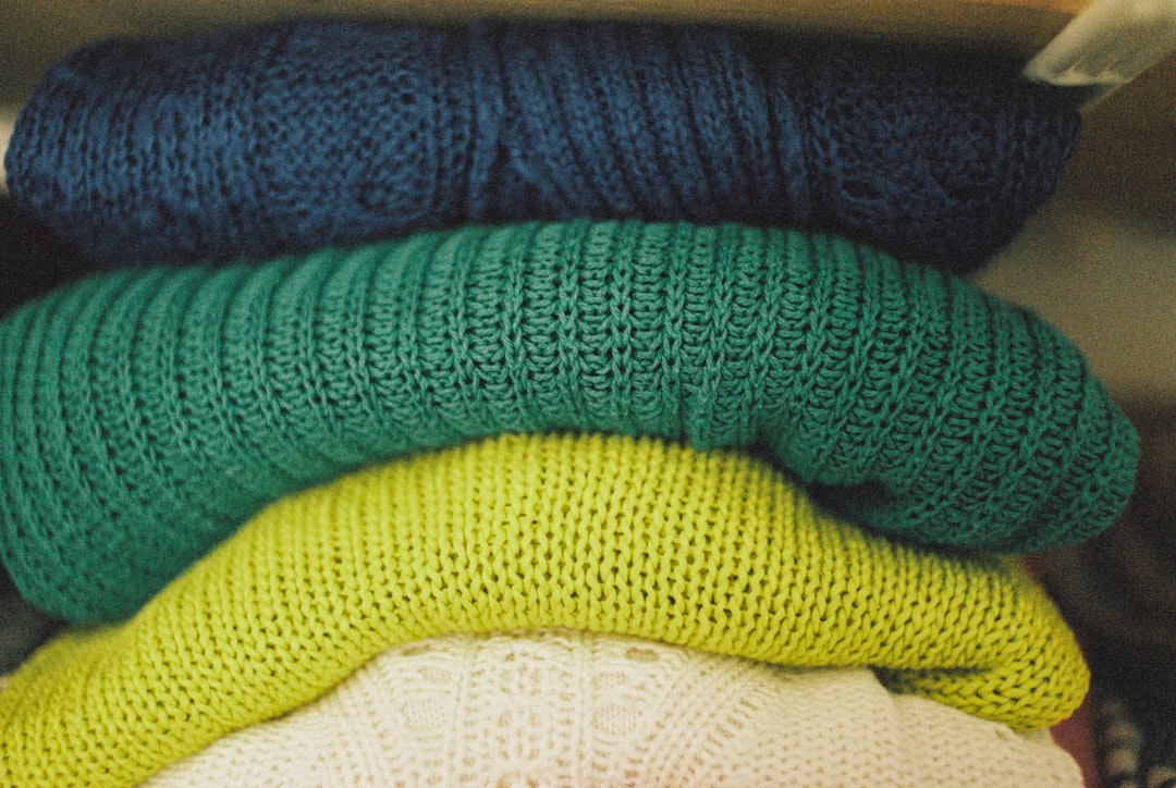 woman choosing colorful knit sweater