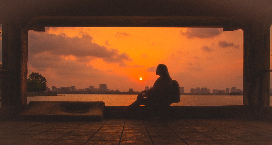 woman meditating sunrise window