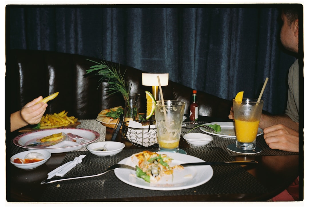Friends dining in a cozy, dimly lit restaurant Friends dining in a cozy, dimly lit restaurant