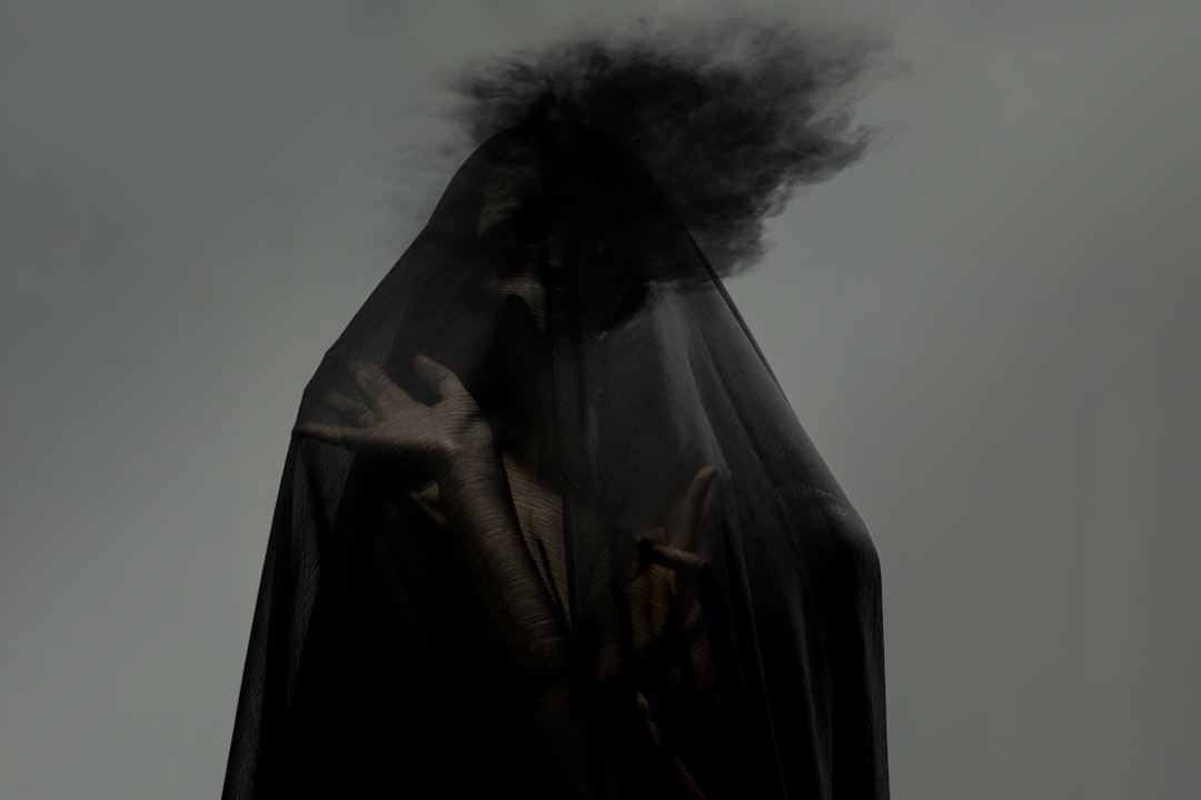 Woman in a luxurious silk robe with a face mask