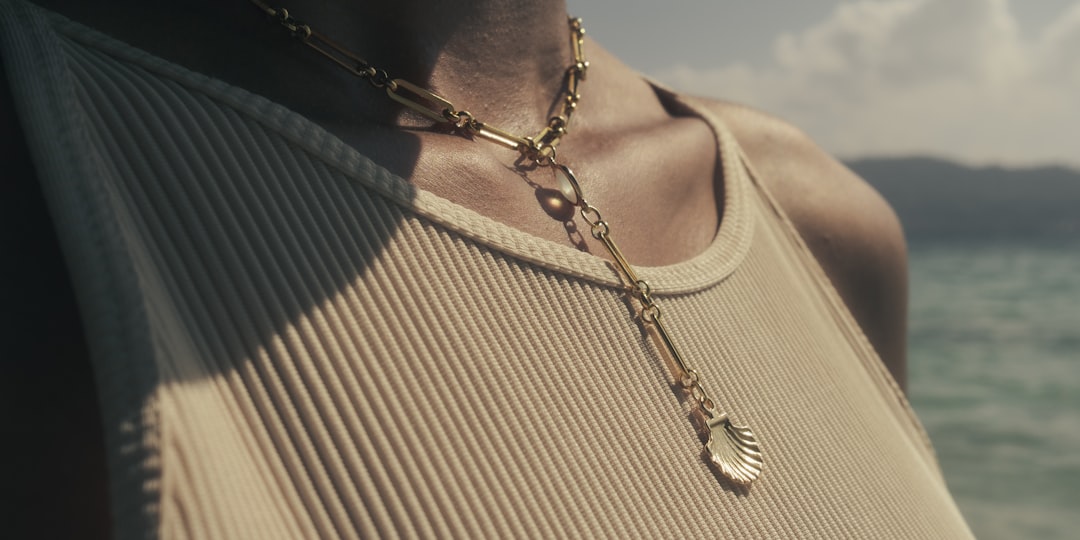 Layered gold necklaces on a model