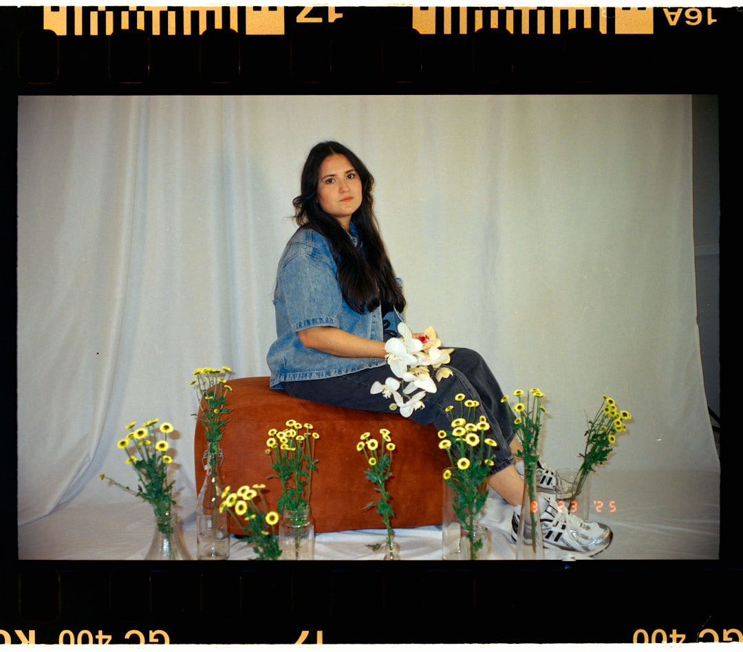 Woman in knit bandeau, oversized shirt, and jeans
