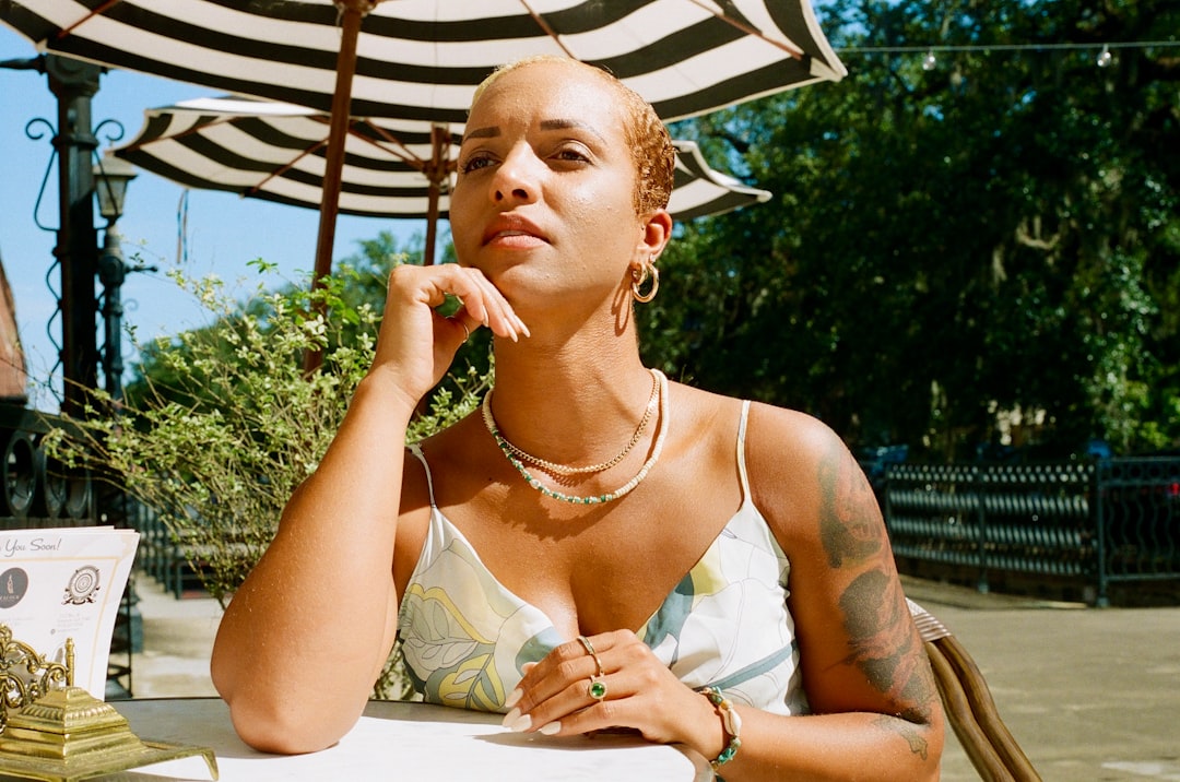Woman wearing a bold gold necklace with simple earrings